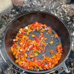 shallots and peppers in Dutch oven.