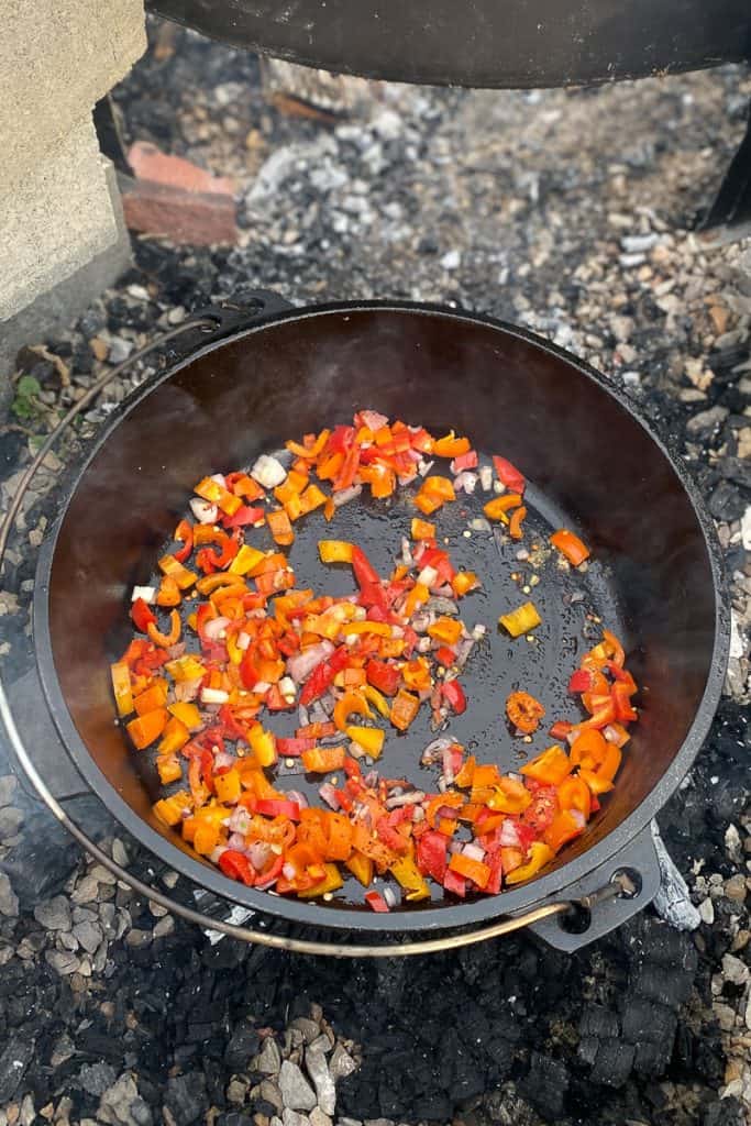 shallots and peppers in Dutch oven.