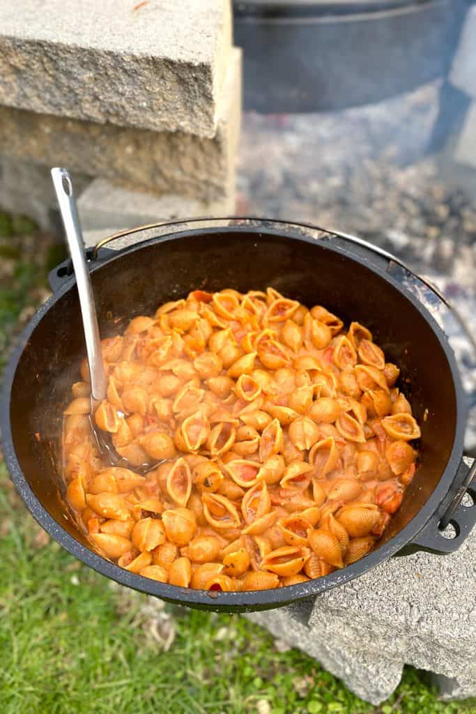 Campfire pasta with vodka cream sauce in dutch oven.