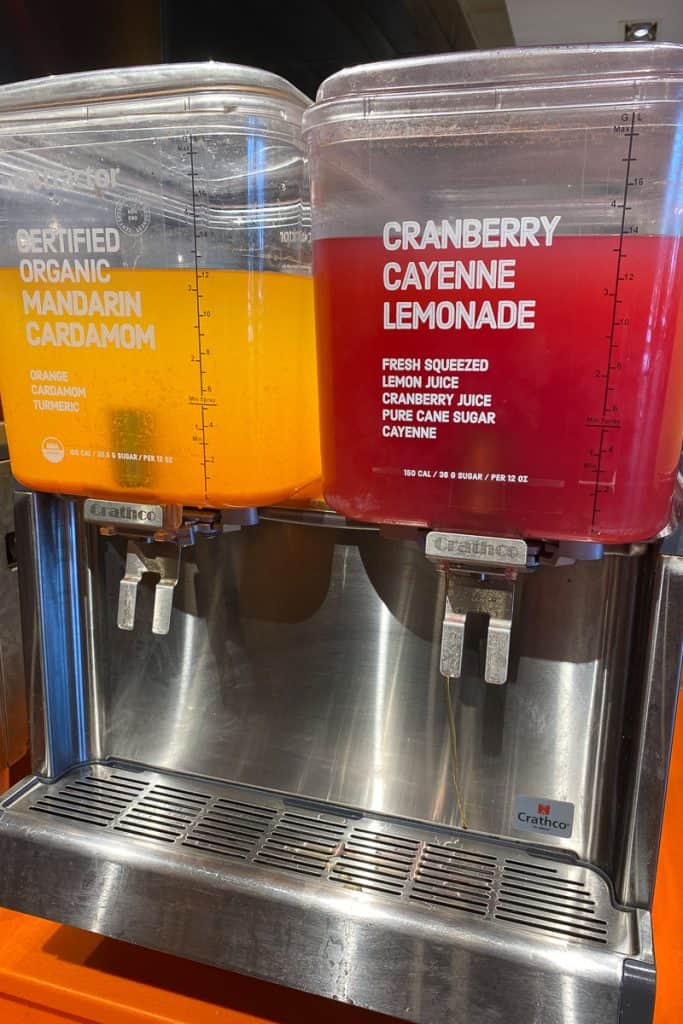 Mandarin cardamom and cranberry cayenne lemonade drink dispensers.