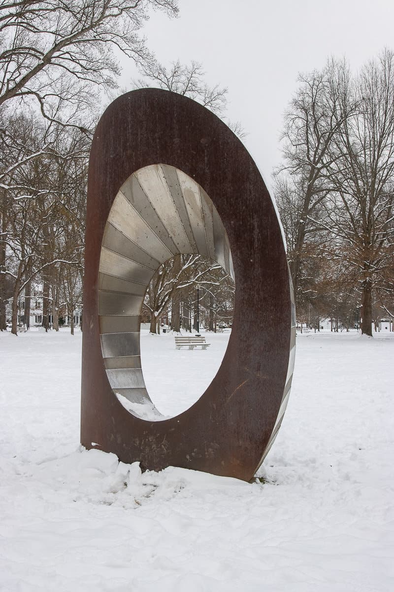 metal sculpture in snowy park.