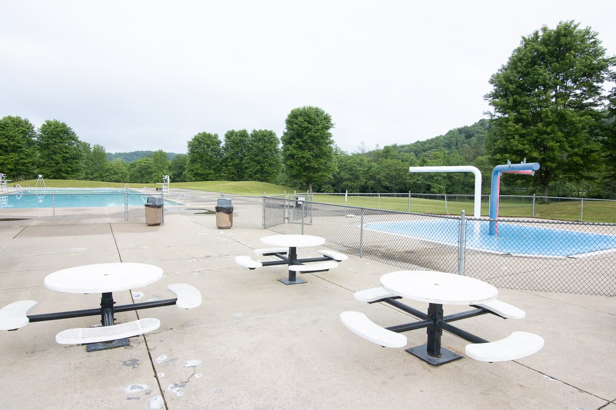 Swimming pool and picnic tables.