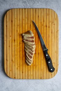Slice tuna with fillet knife.