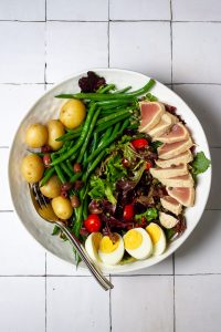 Add tuna to salad on plate.
