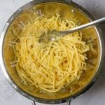 Cooked noodles draining in collander.