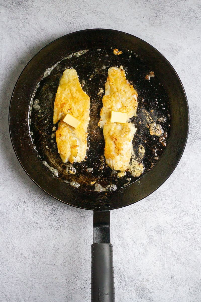 Fish with butter in a pan.