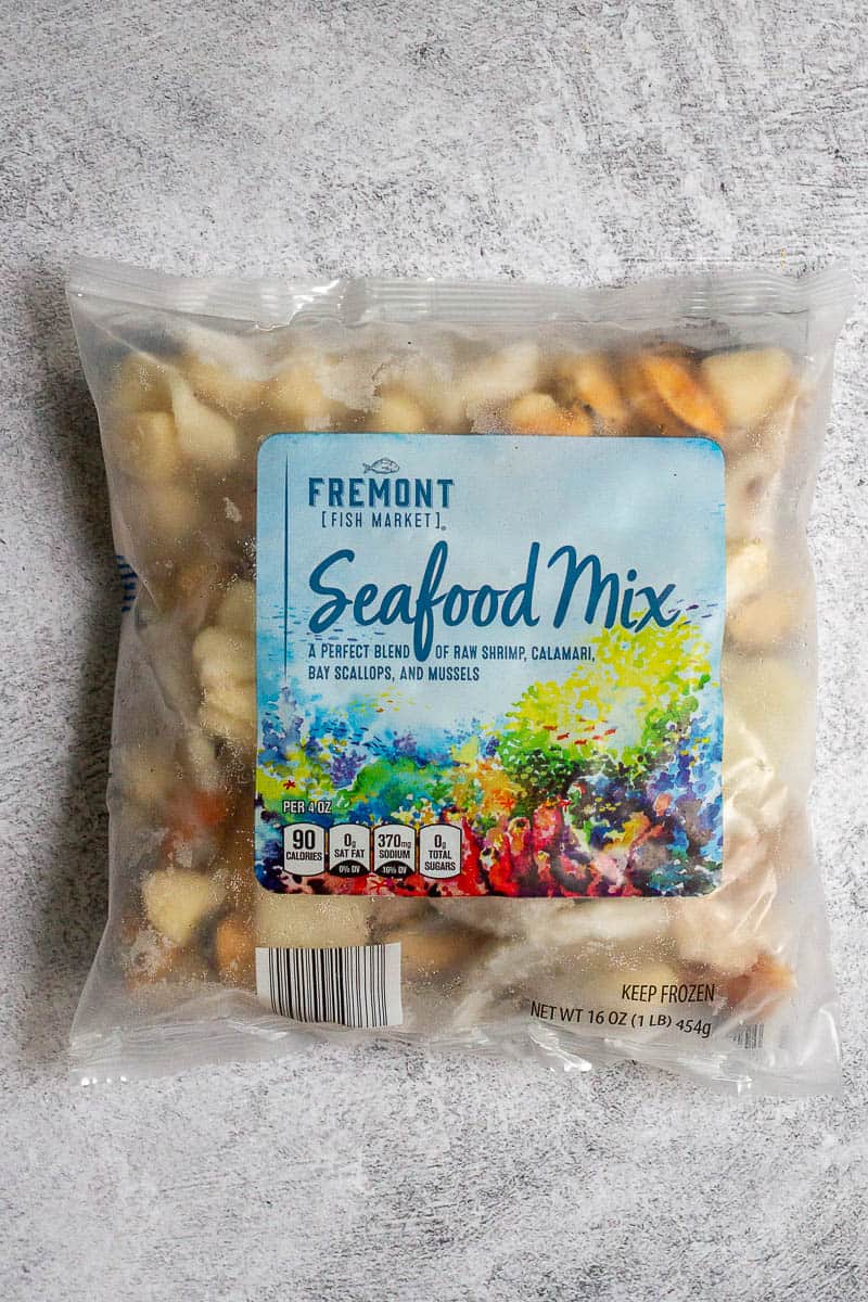 Frozen shrimp, calamari, bay scallops and mussels in bag labeled "Seafood Mix."