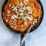 Add seafood mix to cooked pasta and sauce in skillet.