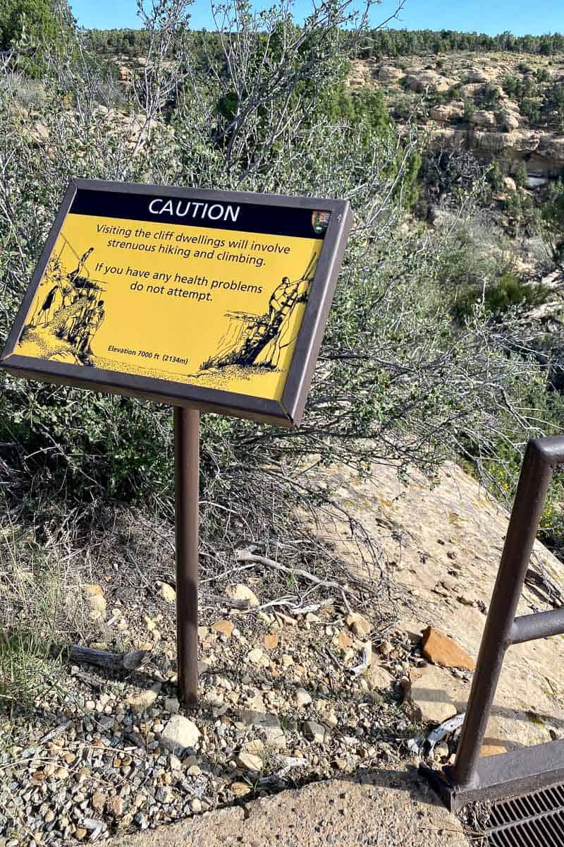 Caution sign warning that cliff dwellings involve strenuous hiking and climbing.