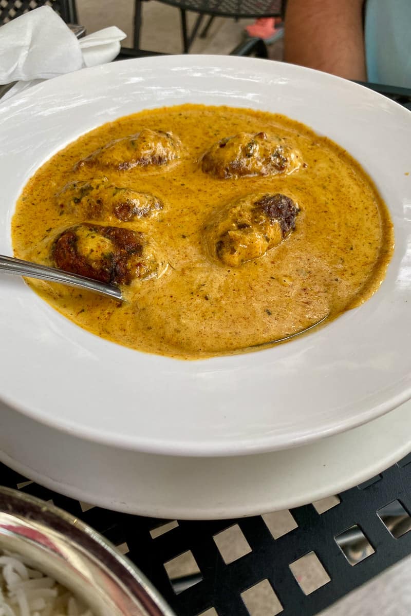 Malai kofta curry in bowl.