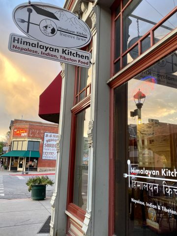 Sign outside building saying "Himalayan Kitchen, Nepalese, Indian, Tibetan Food."