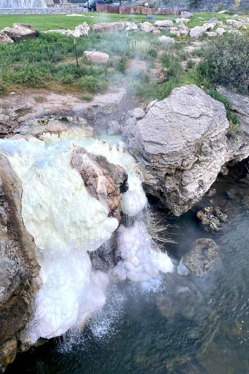 Hot springs with mineral deposits on rocks.