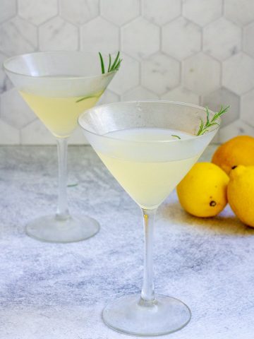 Rosemary bees knees cocktails in martini glasses.