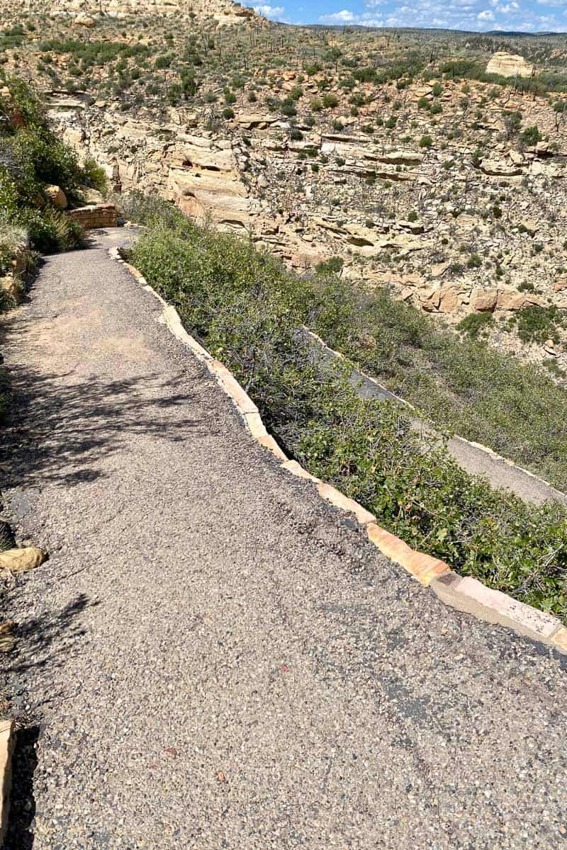 Gravel trail up rocky hillside.