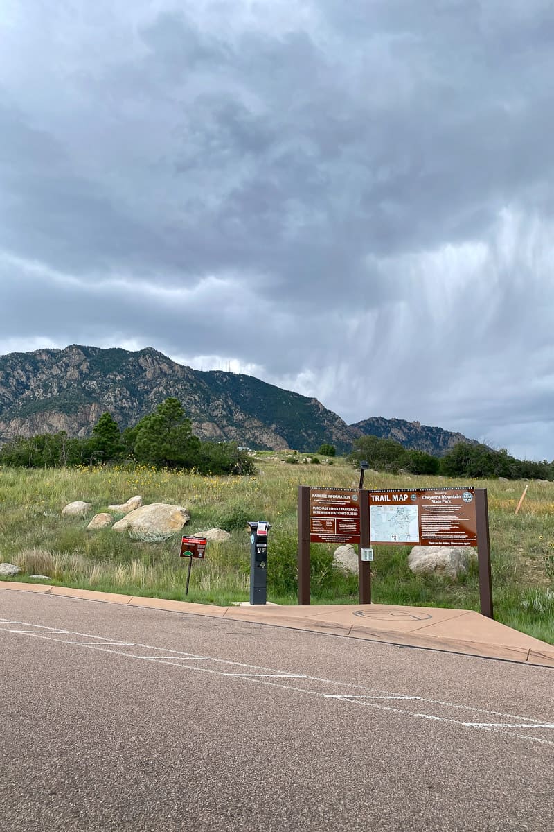 Cheyenne Mountain with trail map sign in foreground.