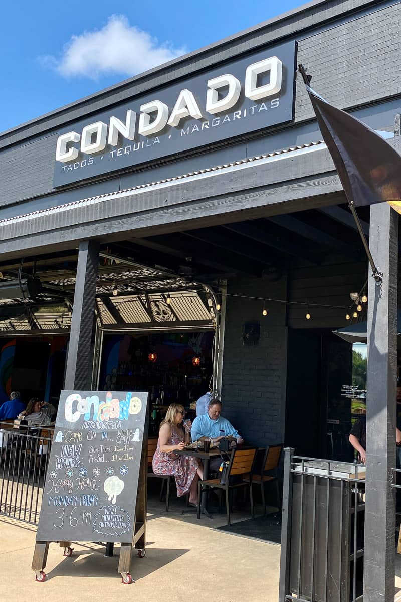 Exterior of Condado restaurant with shelter for outdoor seating area.