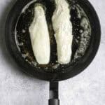 fish fillets in a pan with butter.