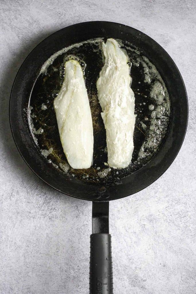 fish fillets in a pan with butter.