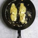 fish fillets in a pan with butter.