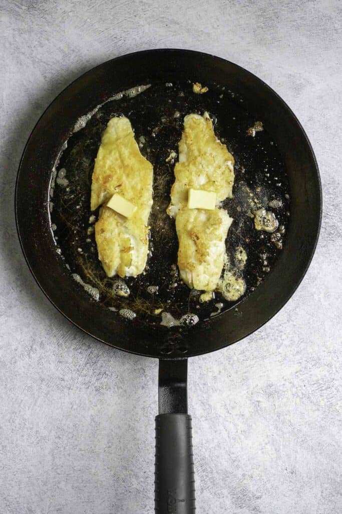 fish fillets in a pan with butter.