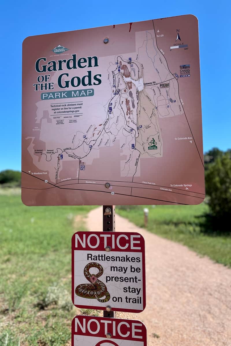 Sign with Garden of the Gods park map and notice about presence of rattlesnakes.