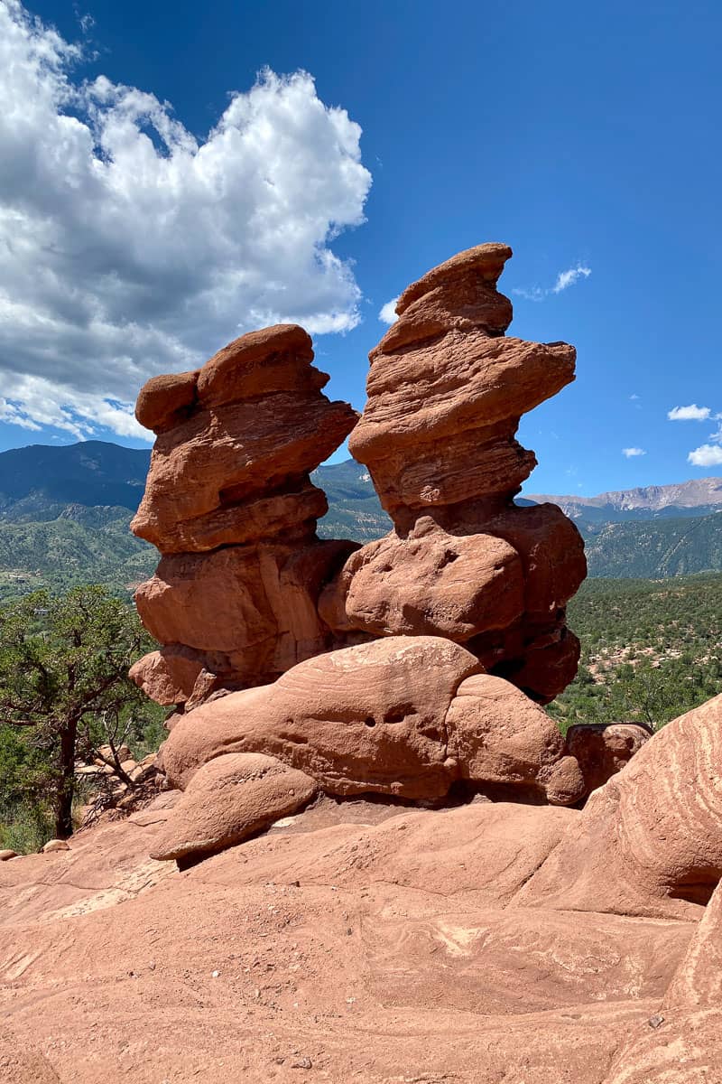 Two towering red rock formations alongside trail.