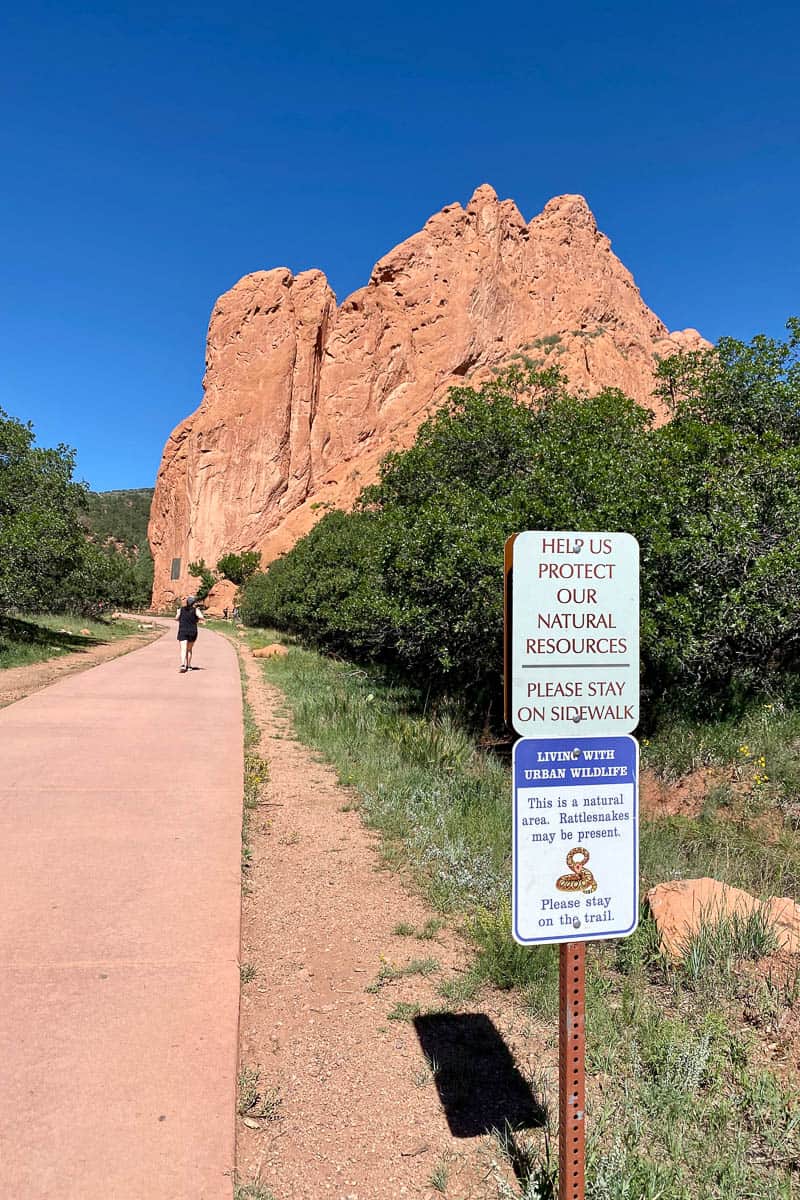 Sidewalk past large red rock formation in Garden of the Gods.