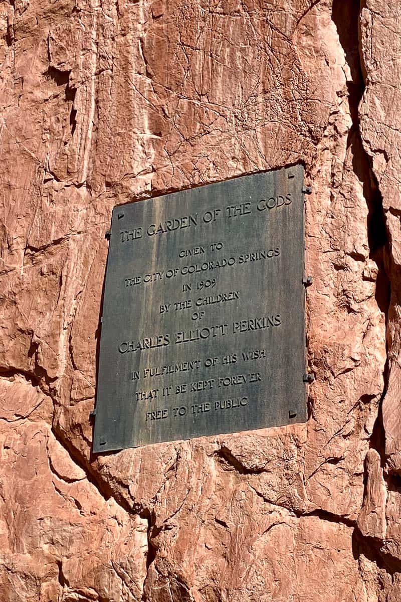 Plaque affixed to rock wall stating history of Garden of the Gods.