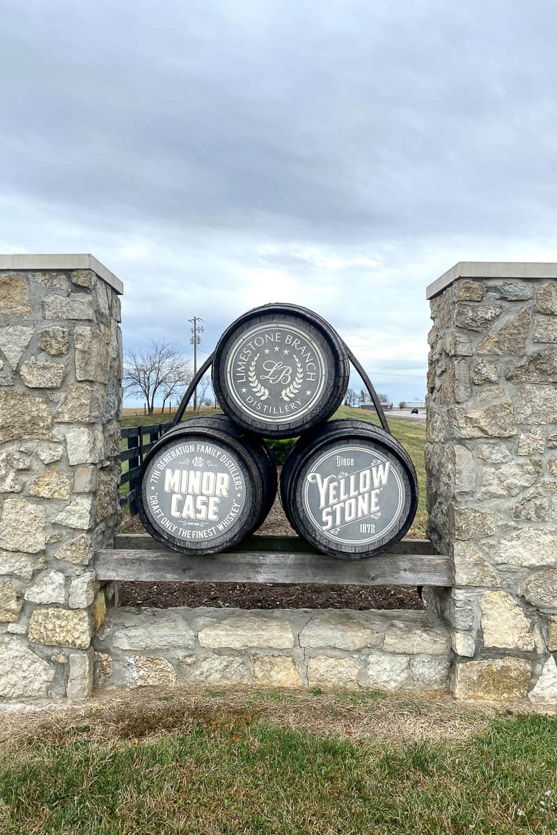Decorative bourbon barrels labeled "Yellowstone," "Minor Case," and "Limestone Branch Distillery."