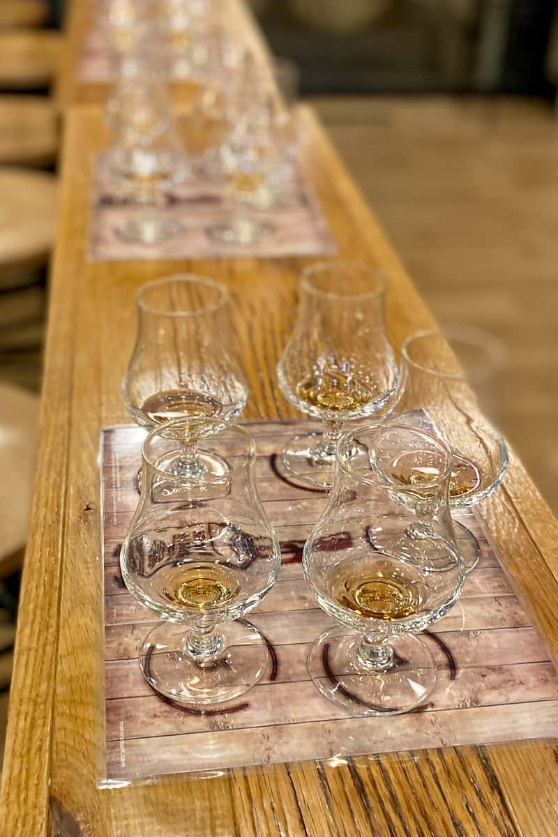 Five bourbon glasses with sample pours on Makers Mark Ambassador Tour.