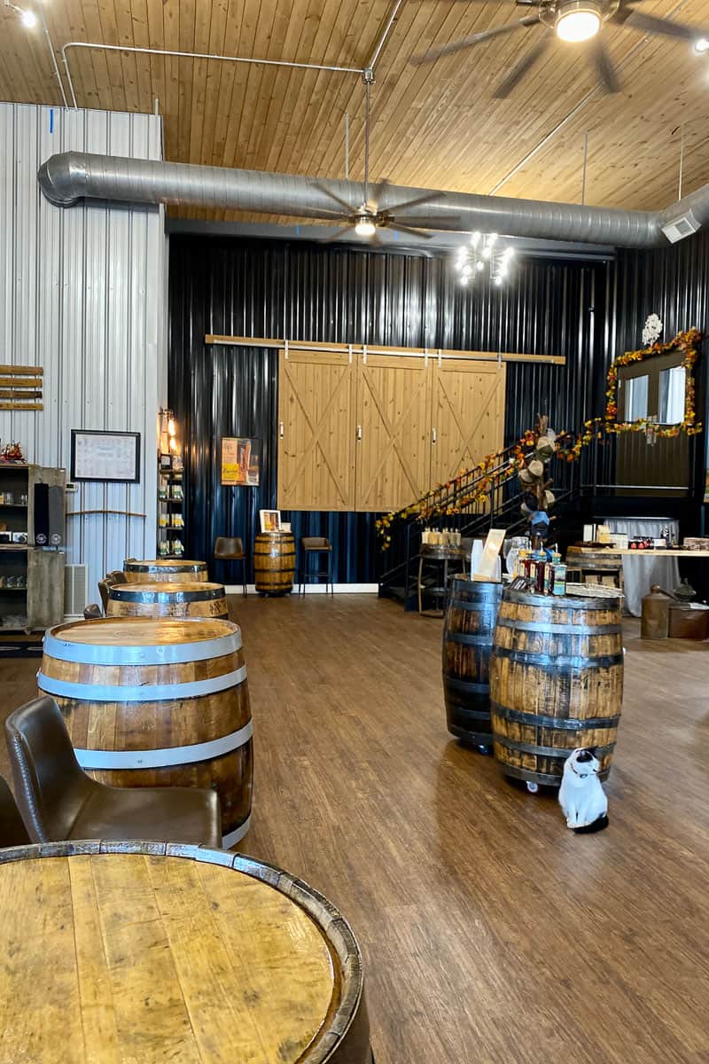Multiple barrels placed next to chairs in bourbon tasting area.