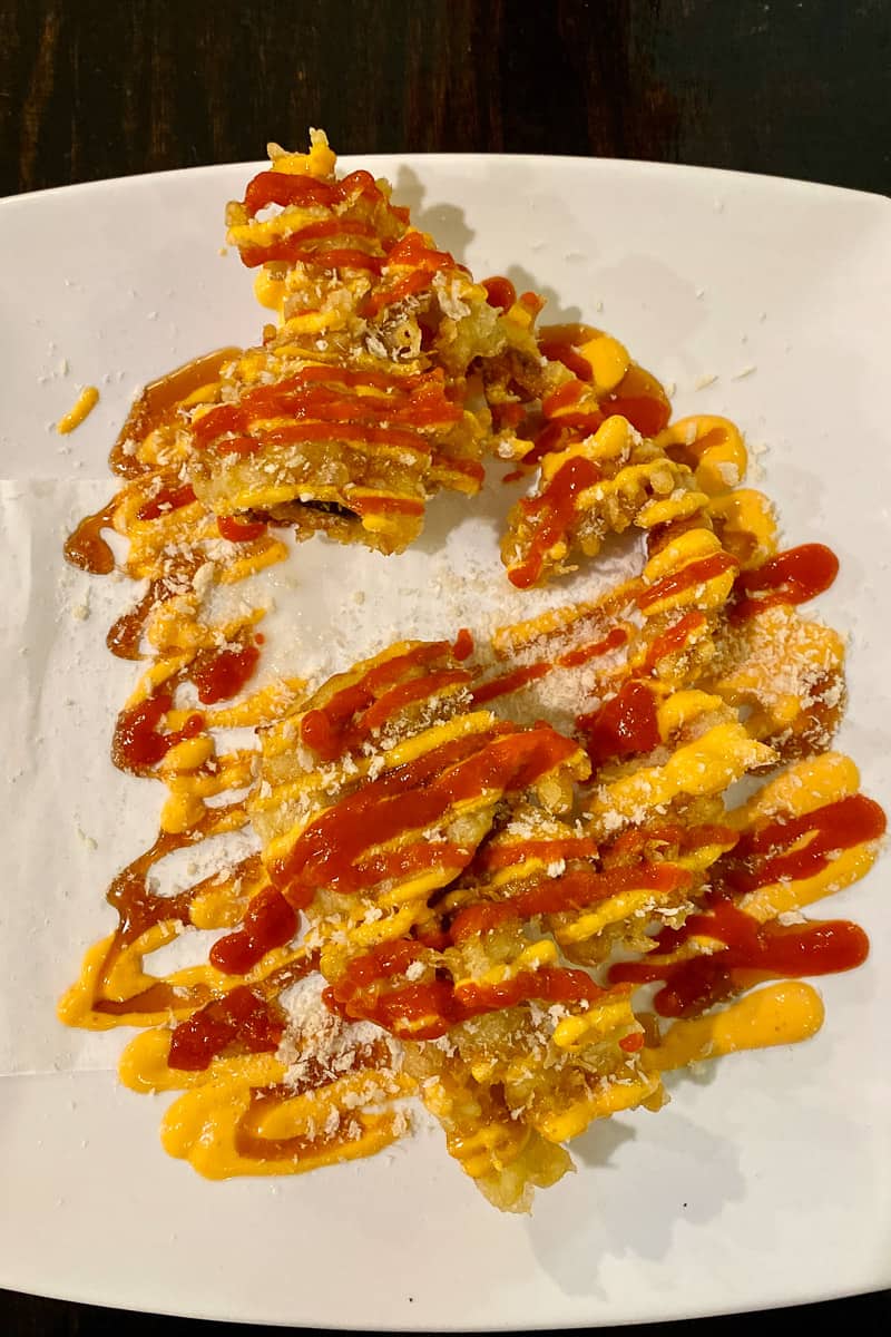 Soft shell crab drizzled with hot sauce.
