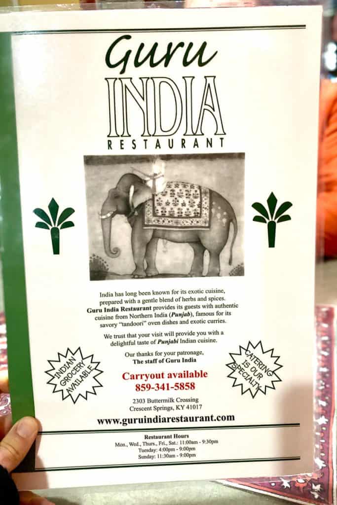 Cover of Guru India Restaurant menu with hours and website listed.