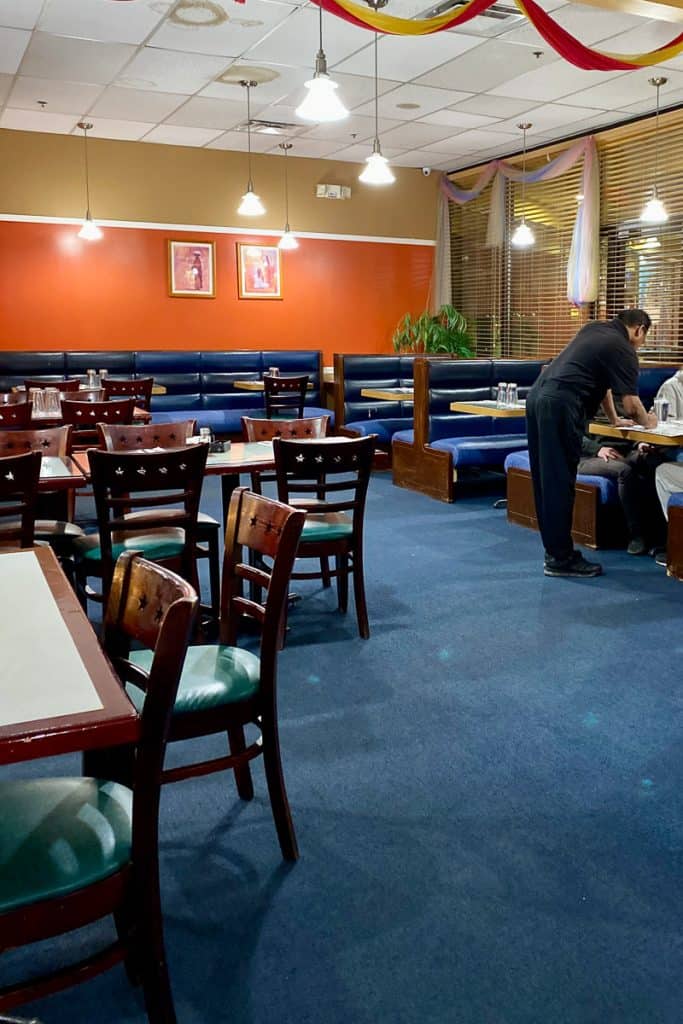 Tables and booths at Guru India Restaurant.