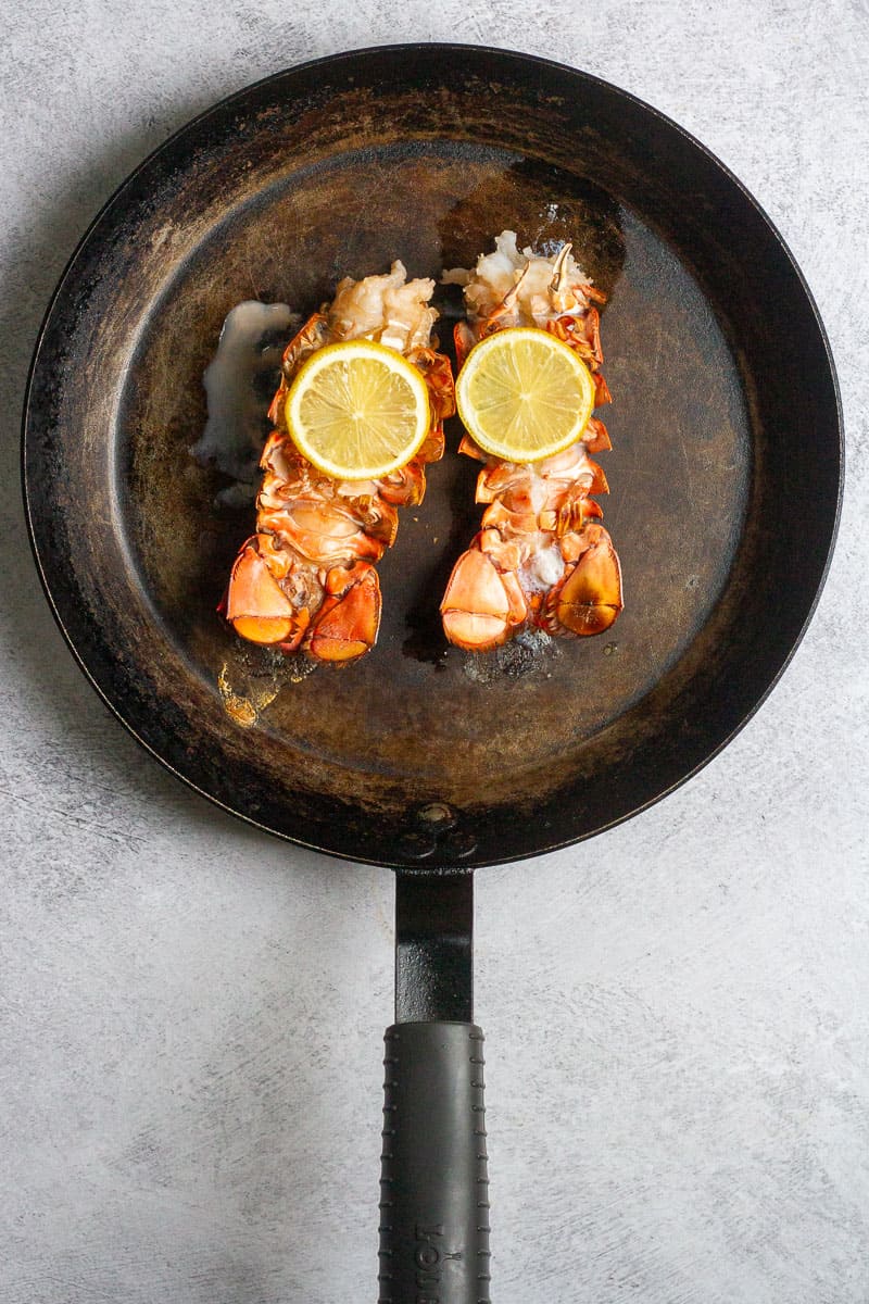 broiled lobster tails in a pan.