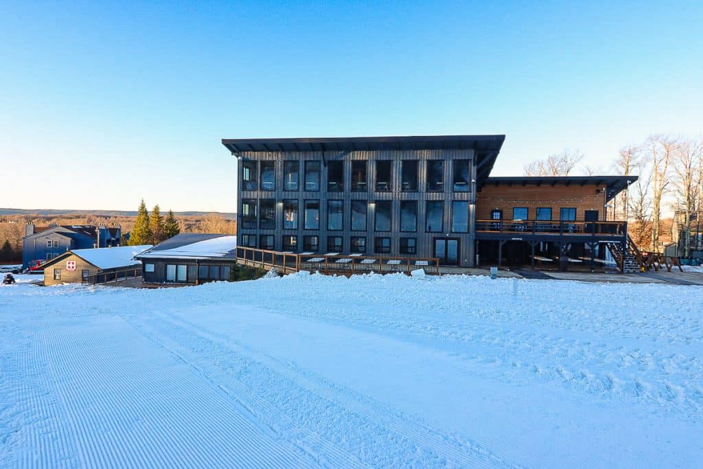 Timberline Ski Lodge, a multi-story building with large glass windows on a snowy hill.