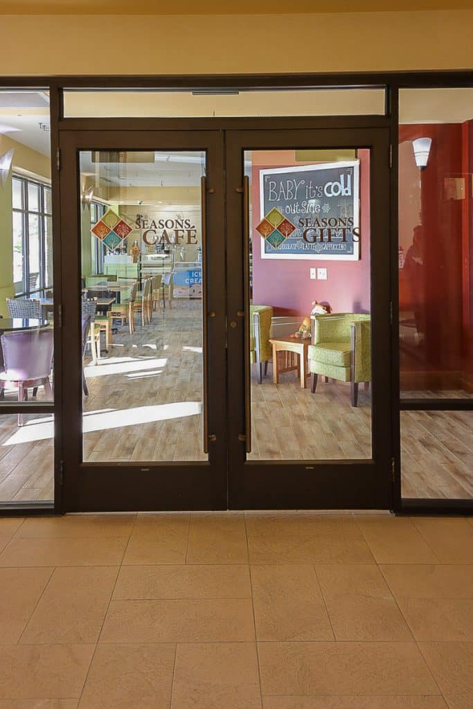 Seasons Cafe with tables, chairs and large windows.