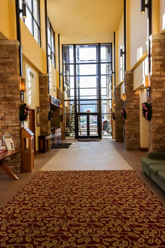 Canaan Lodge interior hallway with high ceilings and many windows.