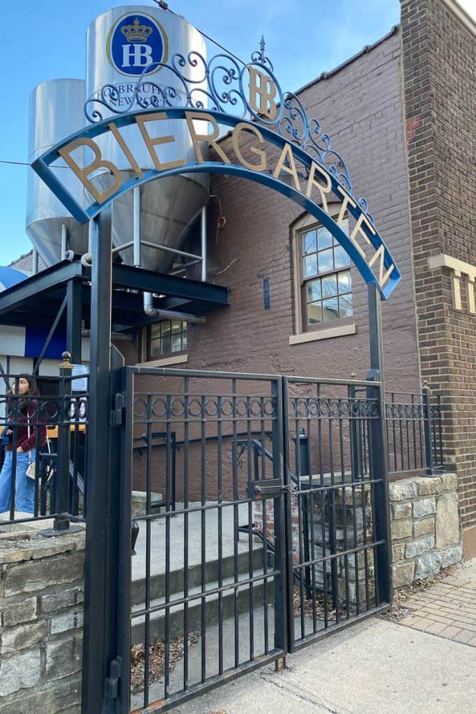 Gate in front of brick building with sign reading "Biergarten."