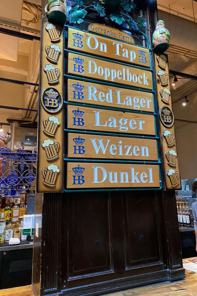 Wooden plaques listing beers on tap at the bar at Hofbrauhaus.