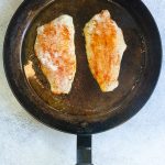 seasoned catfish in a pan.
