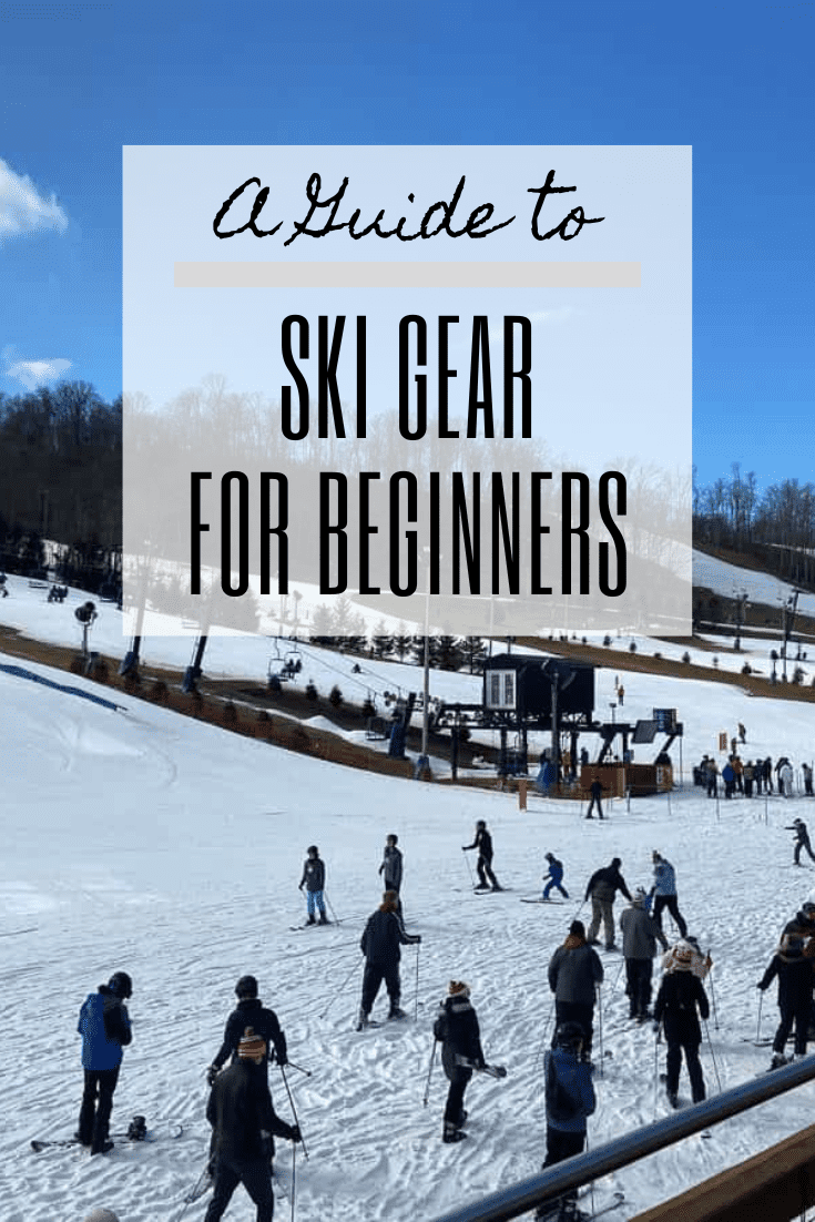 A crowd of skiers of all ages at the foot of a snowy hill, with text box overlaid saying "A Guide to Ski Gear for Beginners."