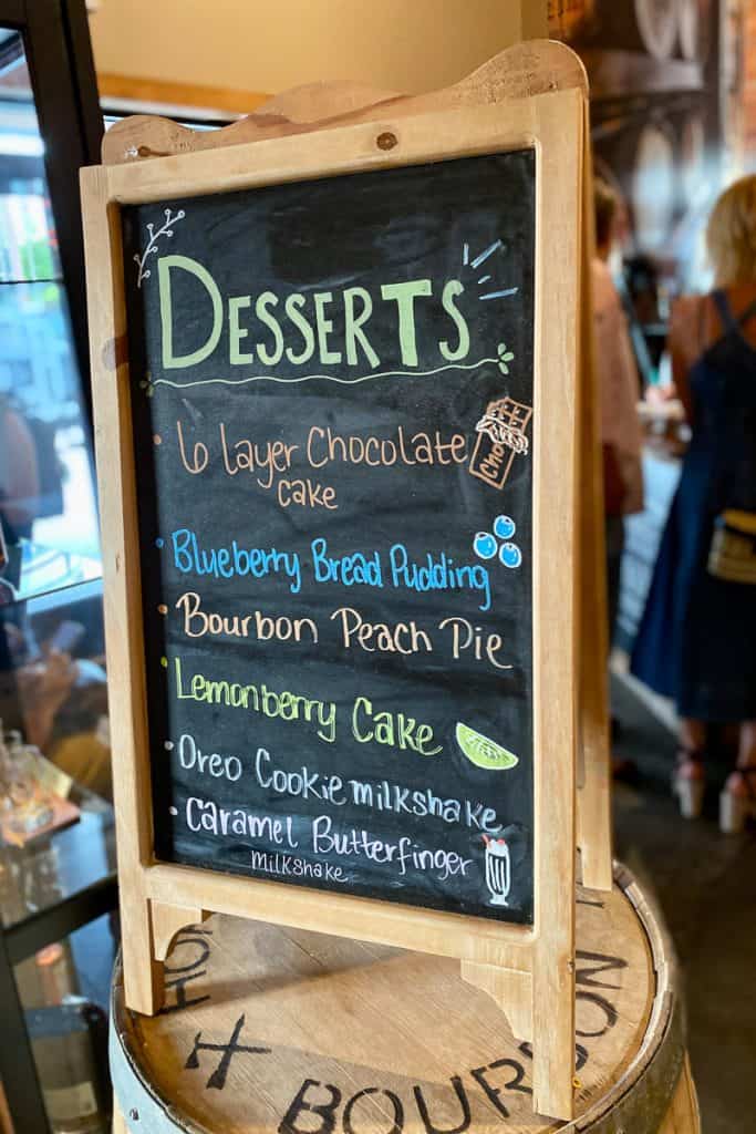 Chalkboard listing dessert options at Charred Oak Whiskey Grill.
