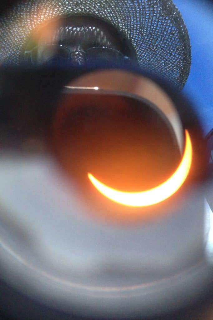 Partial solar eclipse as seen through telescope with filter.
