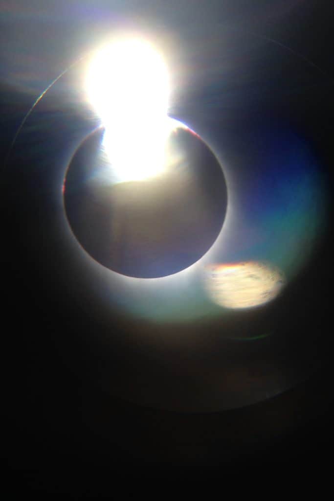 Diamond ring effect as moon begins to move past the sun in the path of totality.