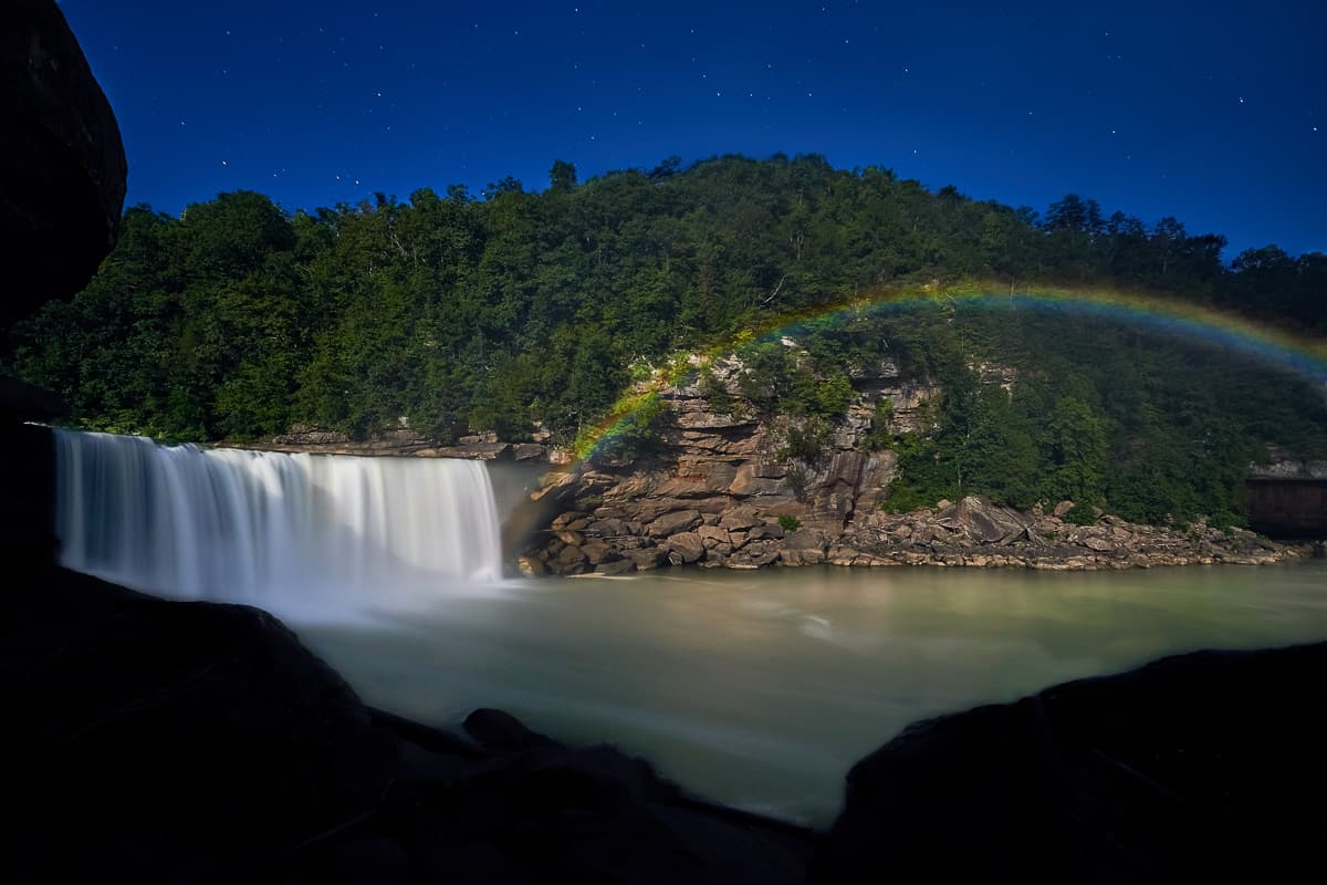 Moonbow next to waterfall.