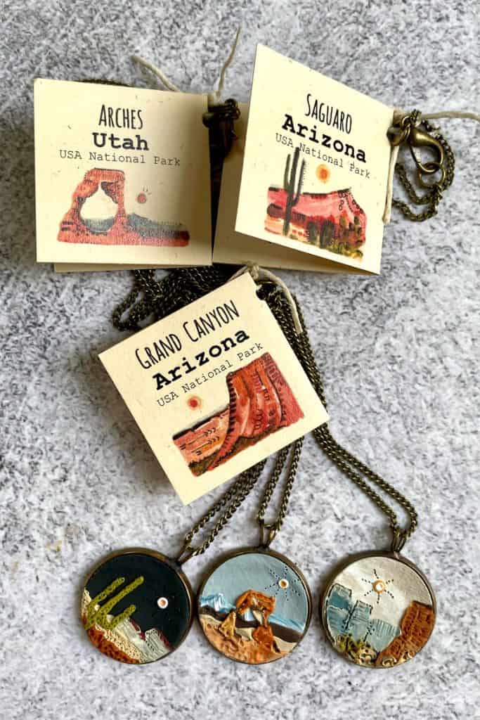 Pendent necklaces displaying scenes from national parks.