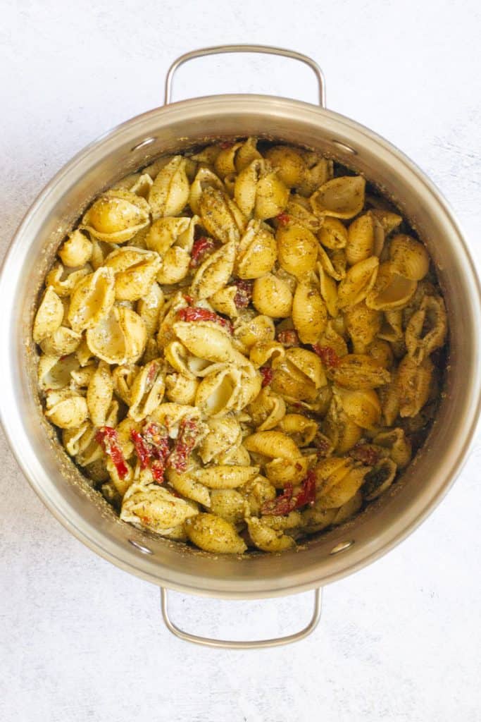 Pasta seasoned with nutritional yeast, pesto and sun-dried tomatoes.