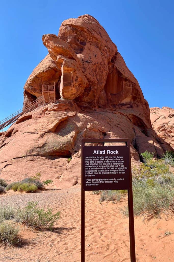 Atlatl Rock, a large red rock formation with a staircase built into it.