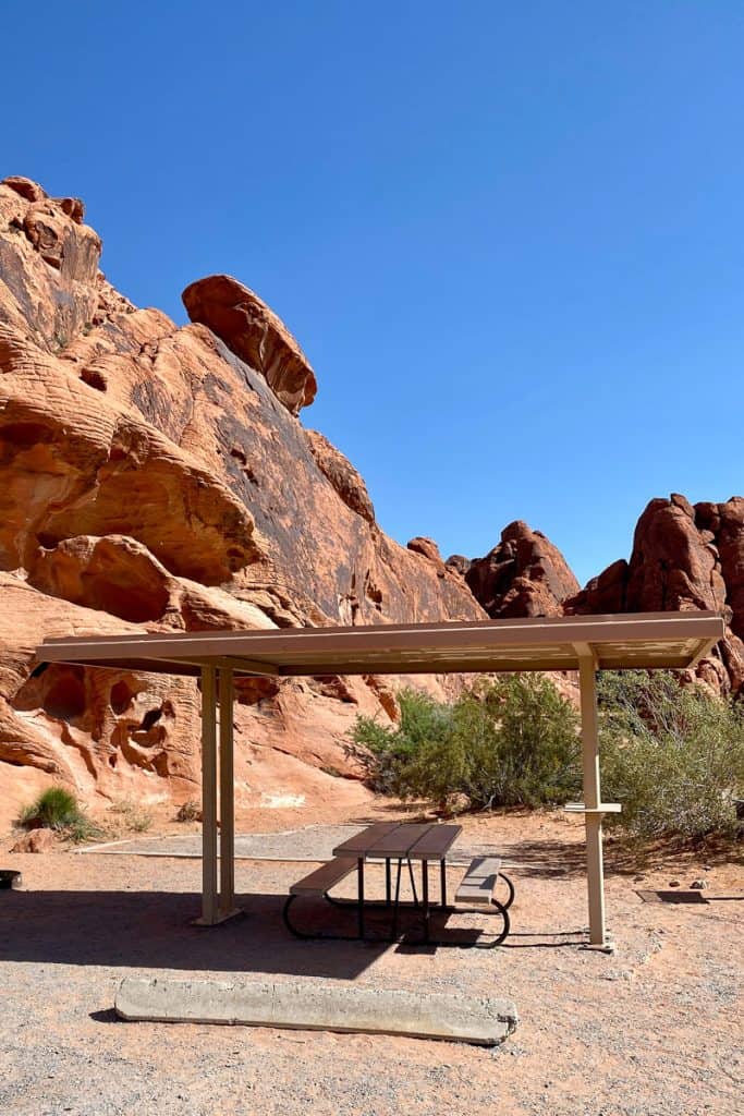 Picnic table under shelter near rock formations at Valley of Fire State Park.